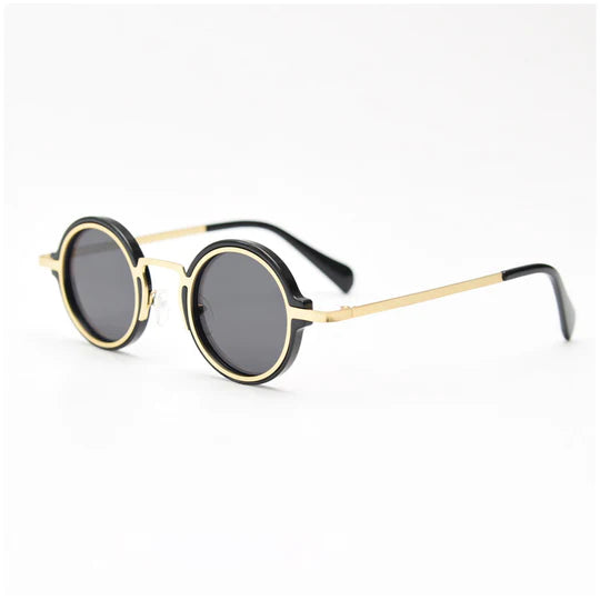 Side view of round-frame sunglasses featuring a gold and black color-block design, with slender gold metal temples and black ear tips.
