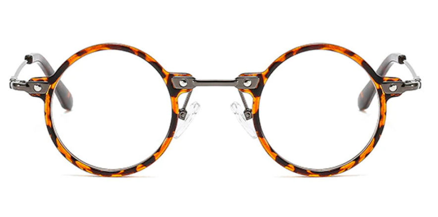 Front view of vintage, perfectly round tortoiseshell-patterned eyeglasses, featuring decorative metal rivets at the bridge and hinges.
