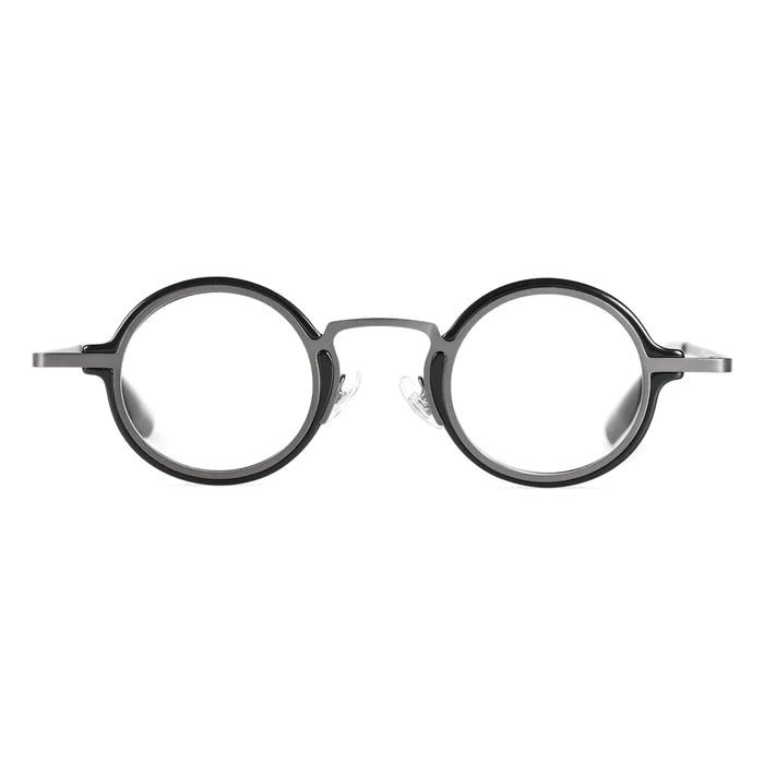 A front view of round, black-framed glasses, featuring a combination design with a slender metal bridge and black acetate rims.