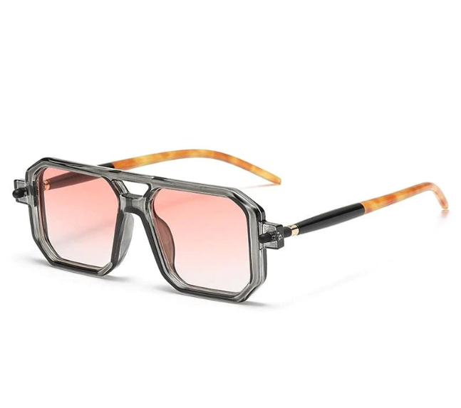 Front view of semi-transparent, grayscale geometric-frame sunglasses, featuring pink gradient lenses and tortoiseshell-patterned temples.