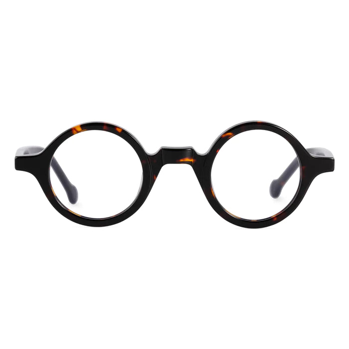 A front view of round, thick-rimmed tortoiseshell glasses, featuring a speckled texture of deep brown and amber tones.