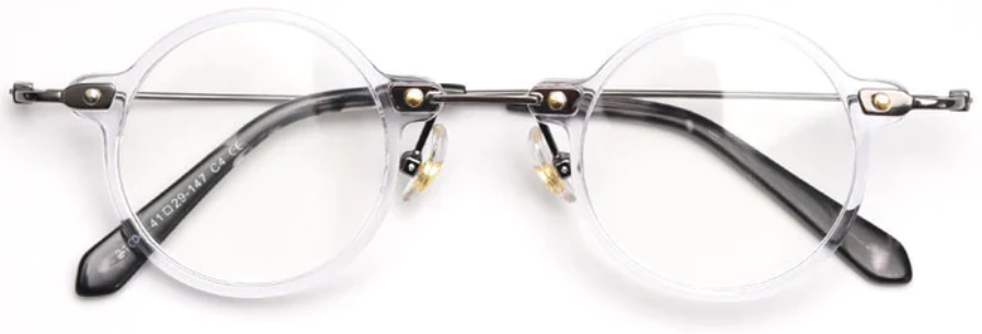 Front view of round, fully transparent frames, featuring a minimalist metal structure at the junction of the frame front and the temples.