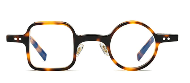 A front view of unique, asymmetrical tortoiseshell-patterned glasses, featuring a square frame on the left side and a perfectly round one on the right.