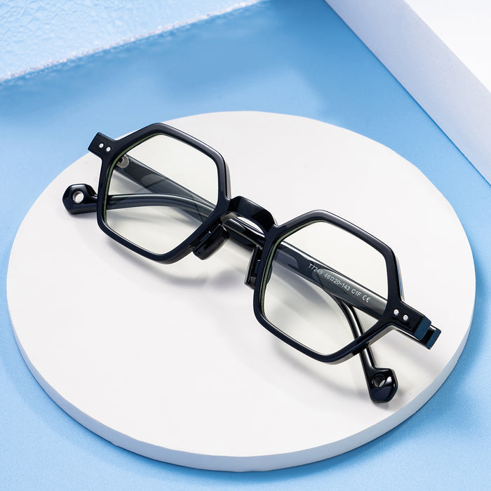 Distinctively designed black, thick-rimmed hexagonal glasses, featuring a circular cutout embellishment on the temples.