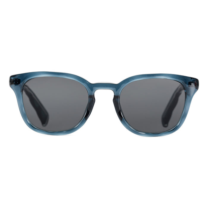 Transparent deep blue acetate sunglasses featuring grey lenses and a classic, slightly rounded square frame design.