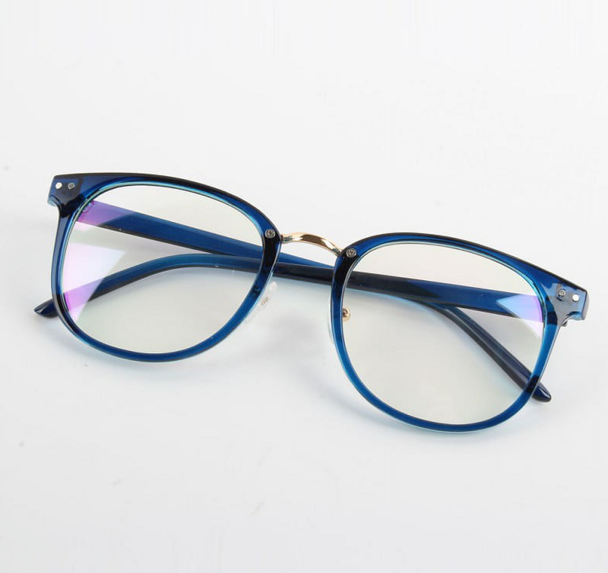 Side view of glasses featuring a thin, transparent dark-blue acetate frame, a gold metal nose bridge, and round lenses.