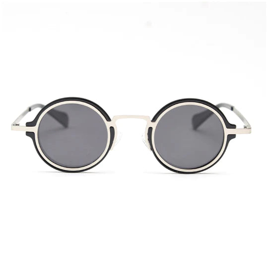 A front view of two-tone black and silver round-frame sunglasses, featuring a chunky black frame accented by silver metal outlines.