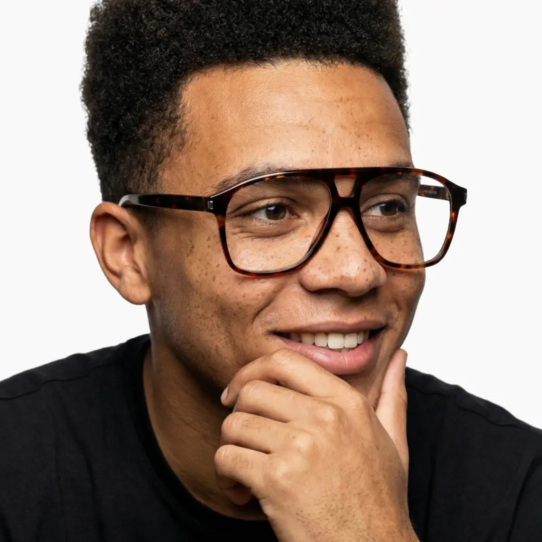 Looking away view of male wearing tortoise aviator eyeglasses, soft smile, AA0062603