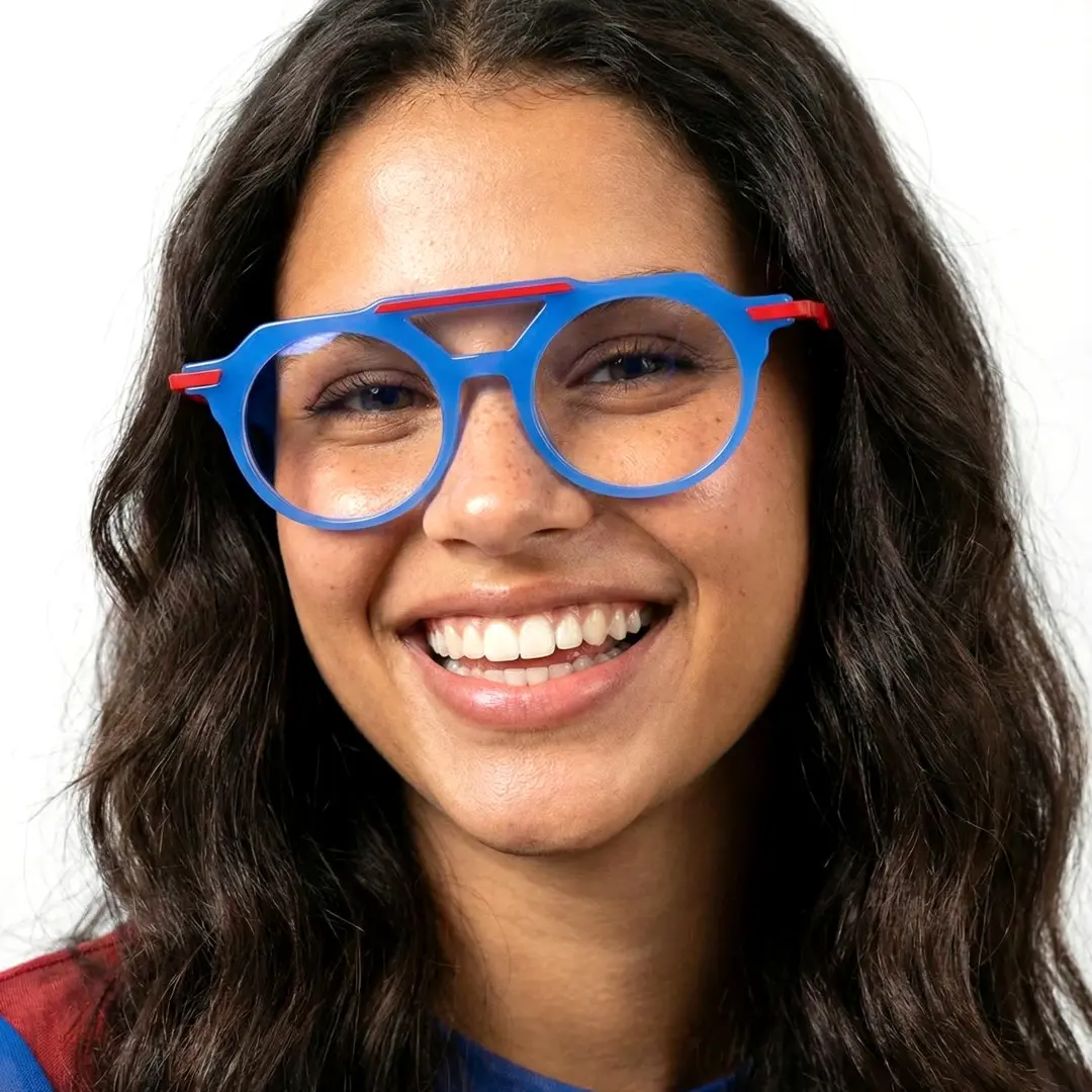 Looking straight ahead view of female wearing vintage blue aviator eyeglasses, wide smile, AA0082302