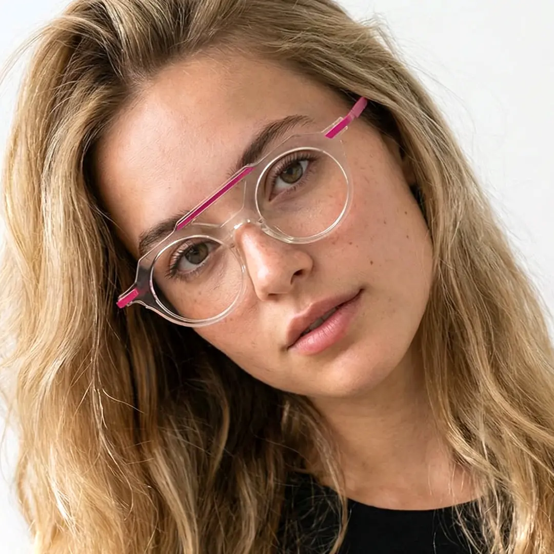 Close-up view of female wearing vintage clear aviator eyeglasses, tilting head, neutral expression, AA0082302