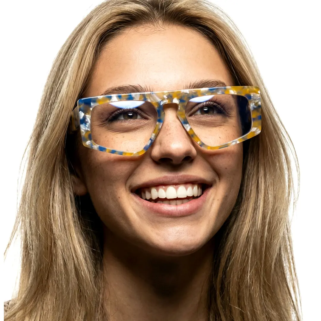 Looking away view of female wearing yellow tortoise aviator eyeglasses, natural smile, AA0122403
