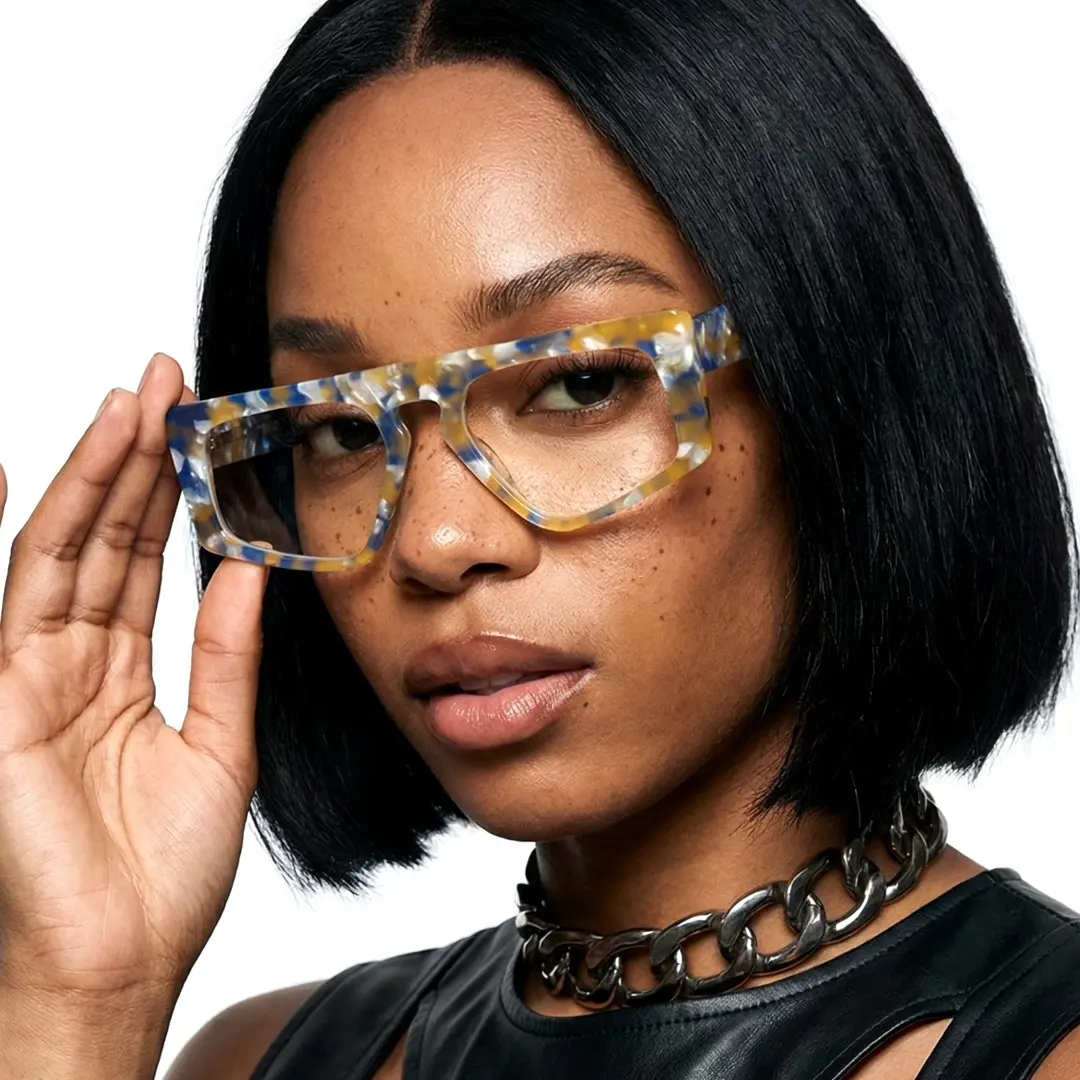 Three-quarter view of female wearing yellow tortoise aviator eyeglasses, touching frame, natural expression, AA0122403