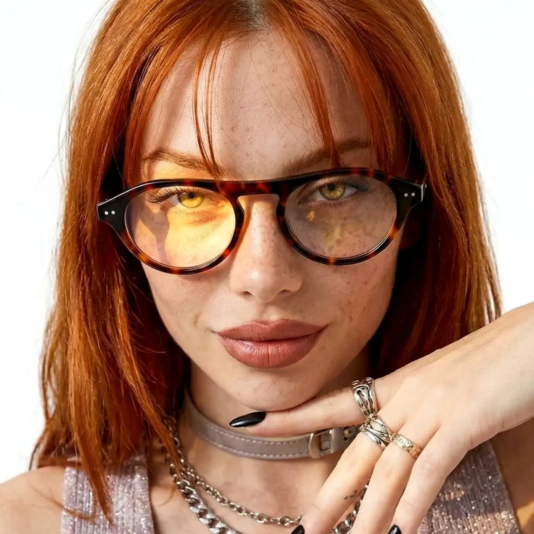 Front view of female wearing vintage tortoise aviator eyeglasses, hand touching chin, neutral expression, AA0222603
