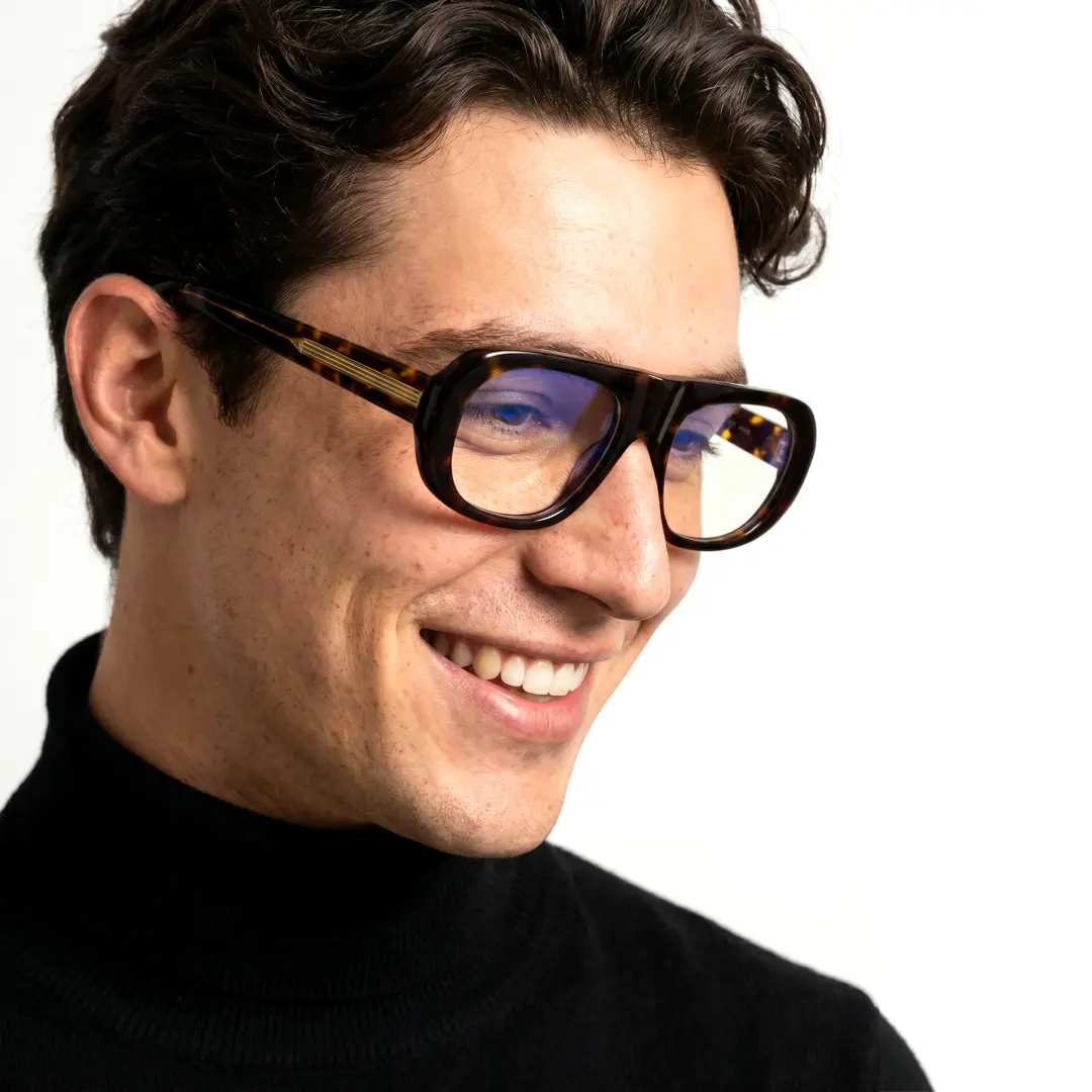Profile view of male wearing vintage tortoise aviator eyeglasses, friendly smile, AA0242604