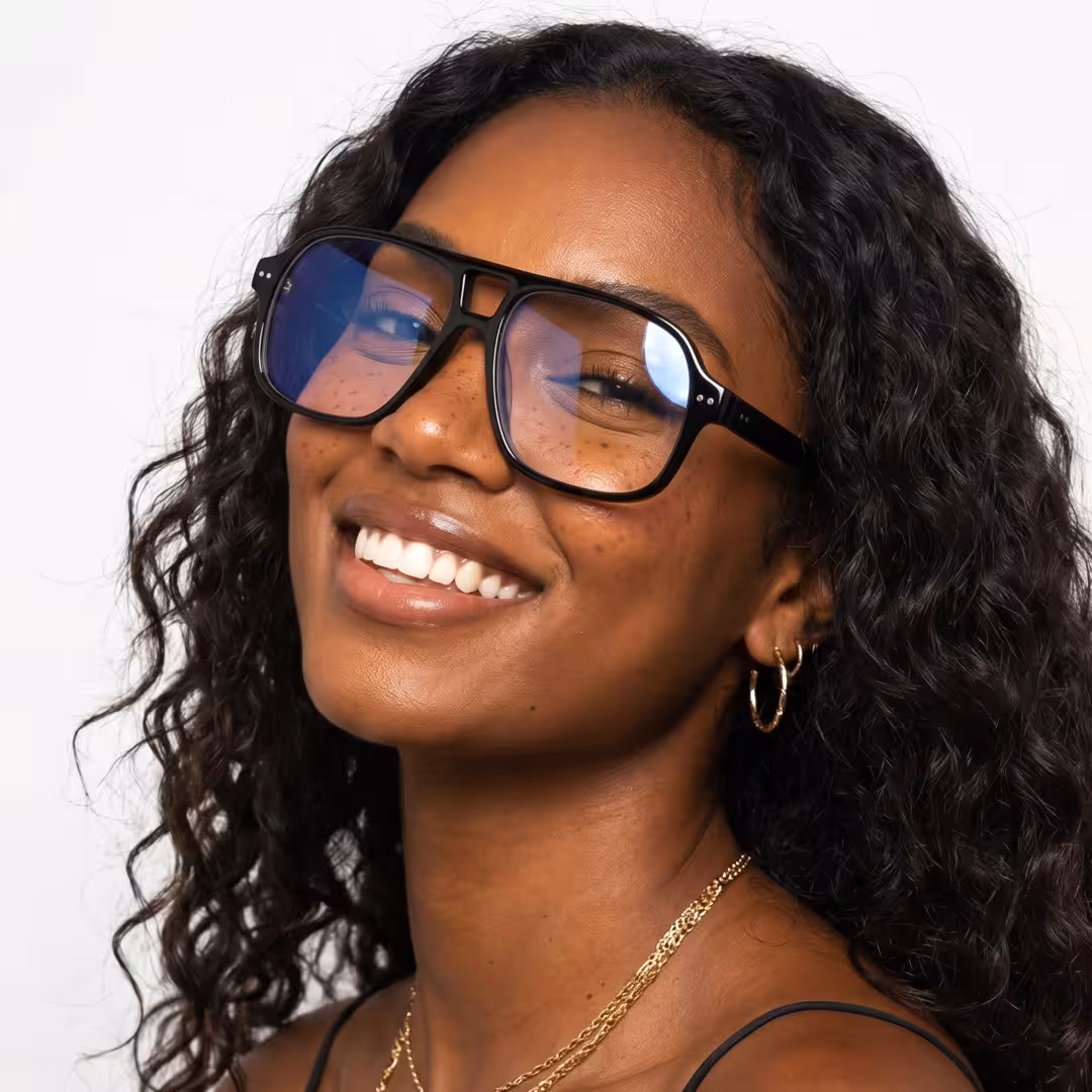 Three-quarter view of female wearing vintage black aviator eyeglasses, smiling, AA0322605