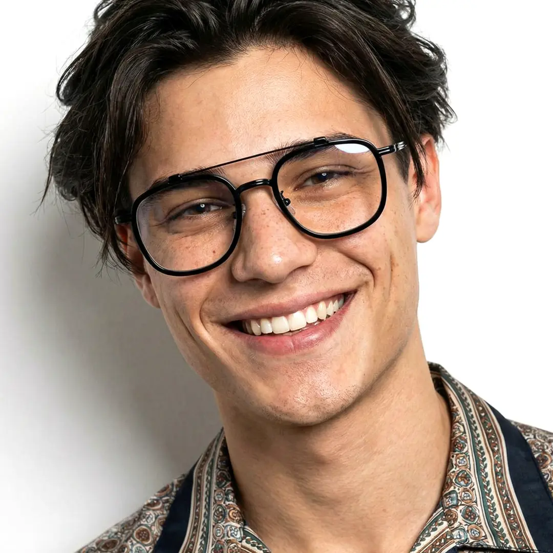 Front view of male wearing black aviator eyeglasses, smiling, AM0242410
