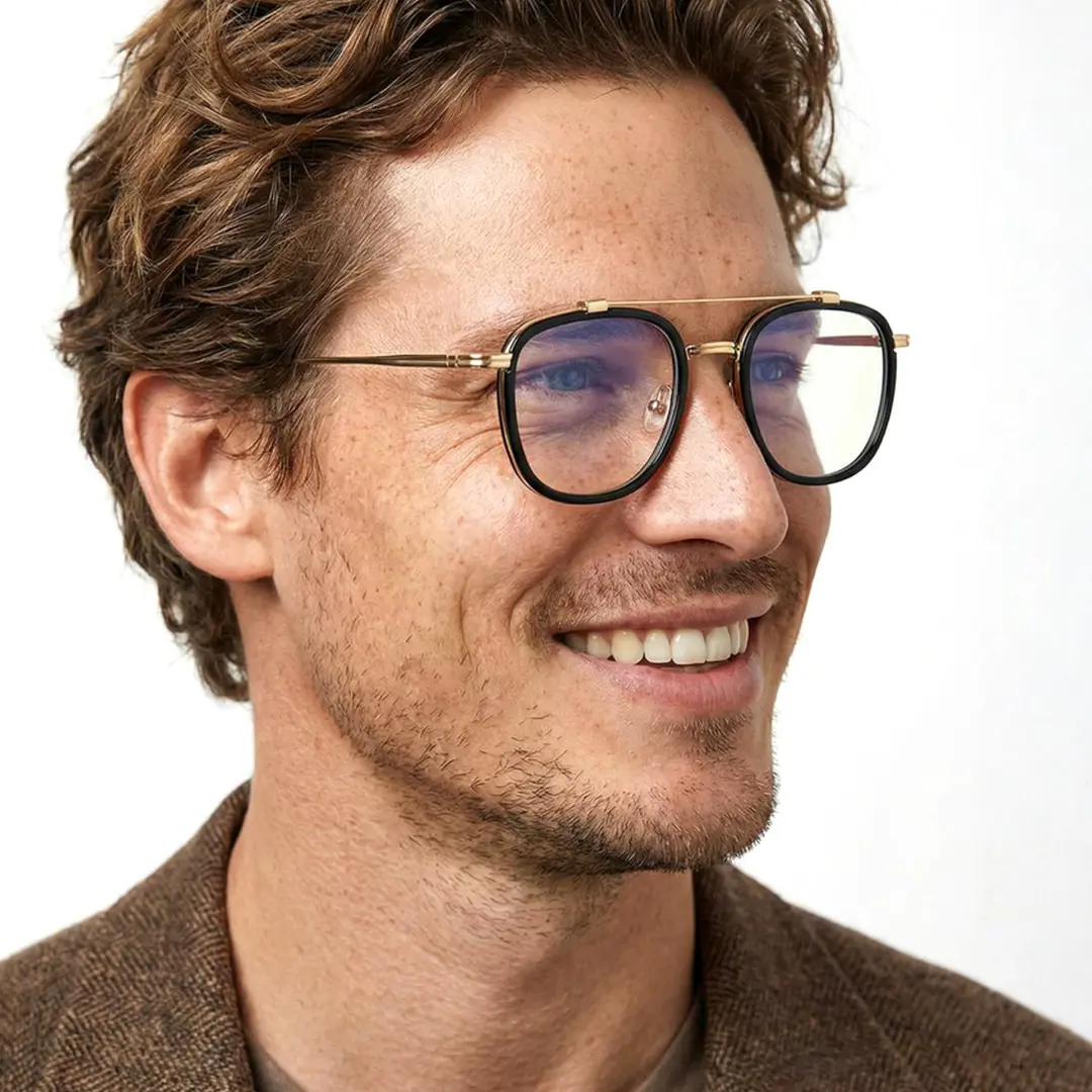 Profile view of male wearing gold aviator eyeglasses, smiling, AM0242410