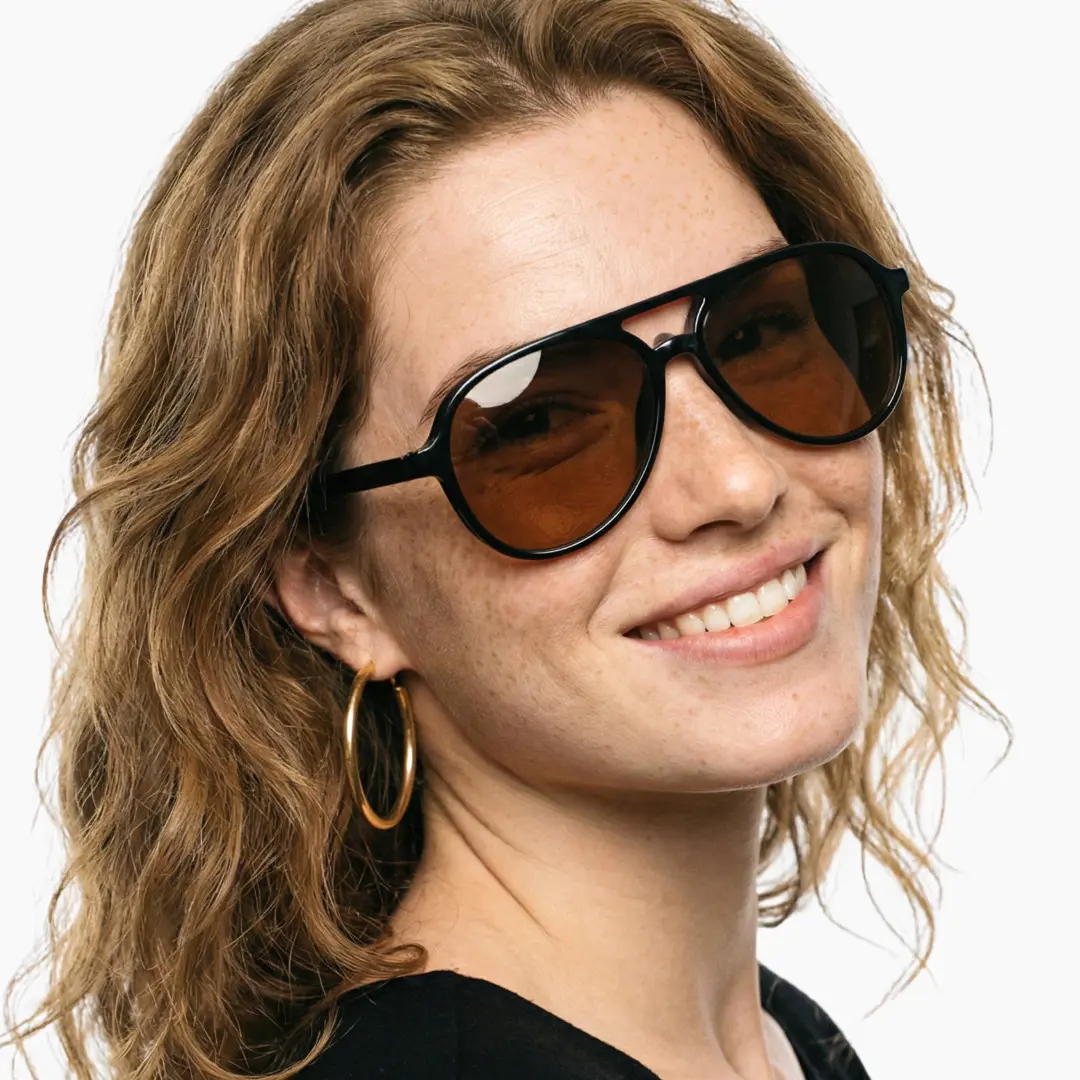Slightly angled view of female wearing black aviator magnetic clip-on eyeglasses set with interchangeable clip-on lenses, smiling, AR0122601