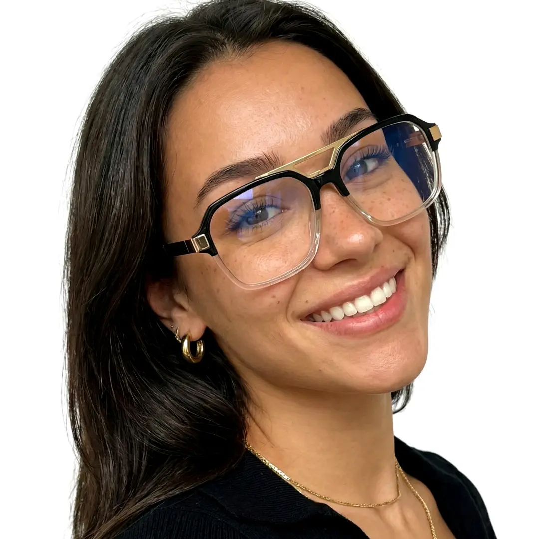 Slightly angled view of female wearing two-tone aviator eyeglasses, tilting head, smiling, AR0292408