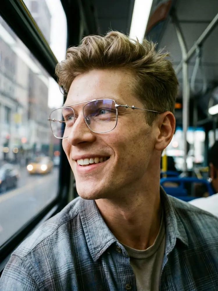 Male model wearing star grey aviator titanium eyeglasses in a city bus. SPU: AT0122412