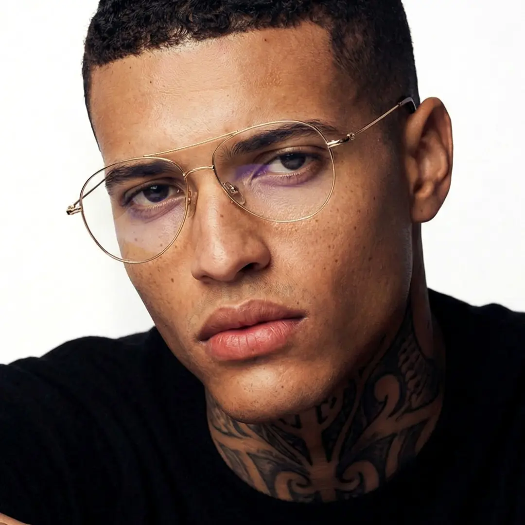 Portrait view of male wearing gold aviator eyeglasses, calm expression, AT0262601