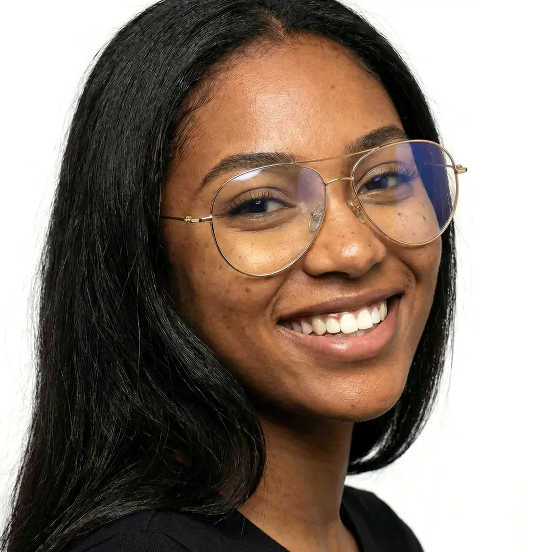Over-the-shoulder view of female wearing vintage gold aviator eyeglasses, smiling, AT0262601