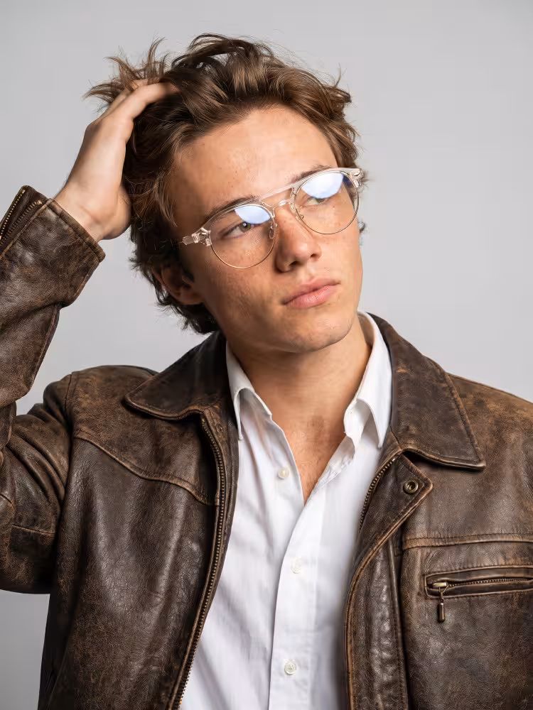 Male model wearing everyday clear aviator tr90 eyeglasses indoors against a plain grey background. SPU: AX0022507