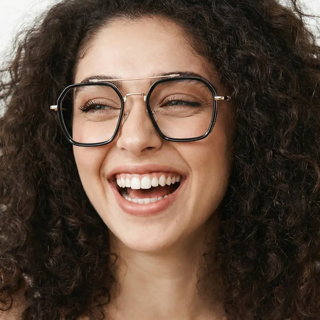 Tilted head view of female wearing black aviator eyeglasses, winking, big smile, AX0122507