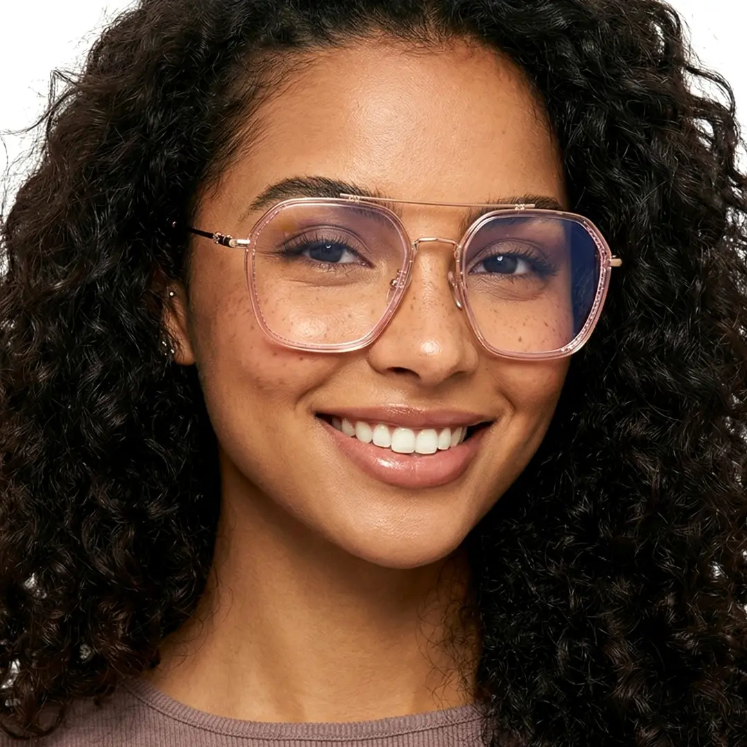 Face close-up view of female wearing pink aviator eyeglasses, friendly smile, AX0132507