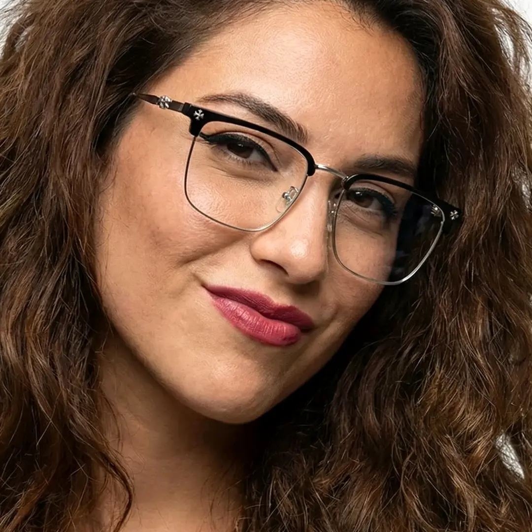 Face close-up view of female wearing silver browline eyeglasses, soft smile, BM0102501