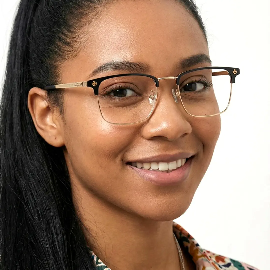 Profile view of female wearing gold browline eyeglasses, friendly smile, BM0112501