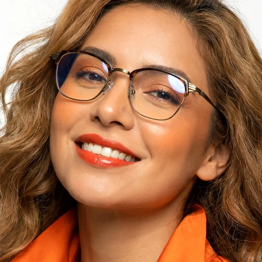 Face close-up view of female wearing tortoise browline eyeglasses, natural smile, BM0252410