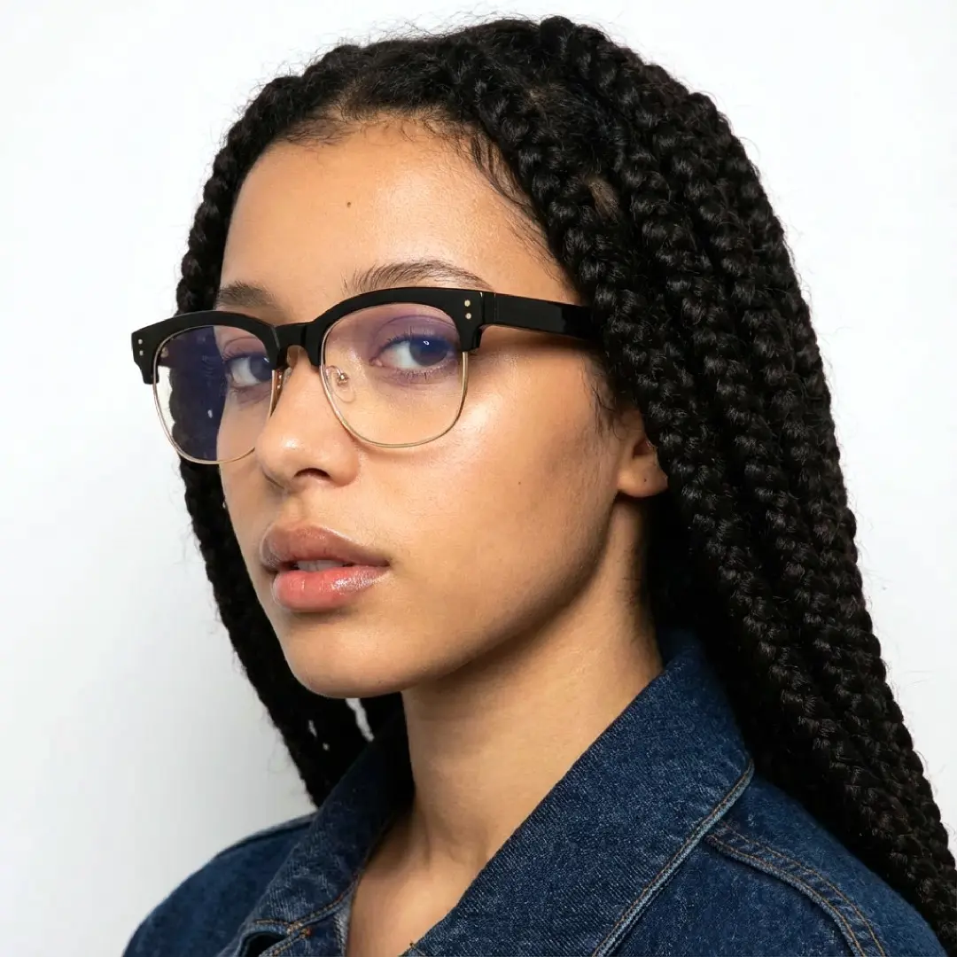 Face close-up view of female wearing black & gold browline eyeglasses, confident expression, BR0012409