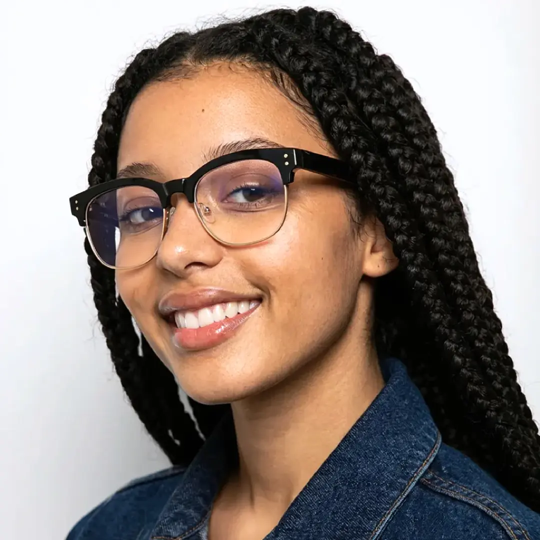 Three-quarter view of female wearing black & gold browline eyeglasses, smiling, BR0012409