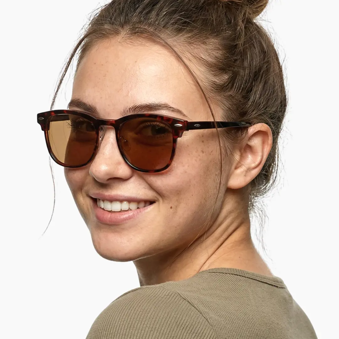 Over the shoulder view of female wearing black browline magnetic clip-on eyeglasses set with brown clip-on lenses, natural smile, BR0102601