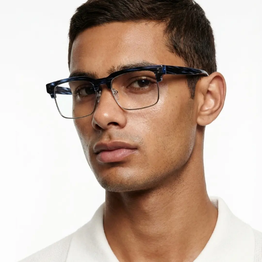 Front view of male wearing blue tortoise browline eyeglasses, relaxed expression, BR0572505