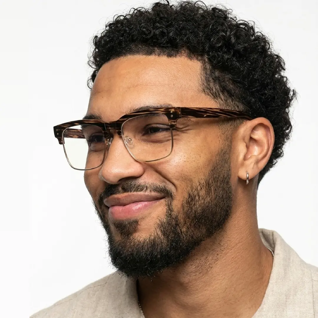 Front view of male wearing tortoise browline eyeglasses, smiling, BR0572505