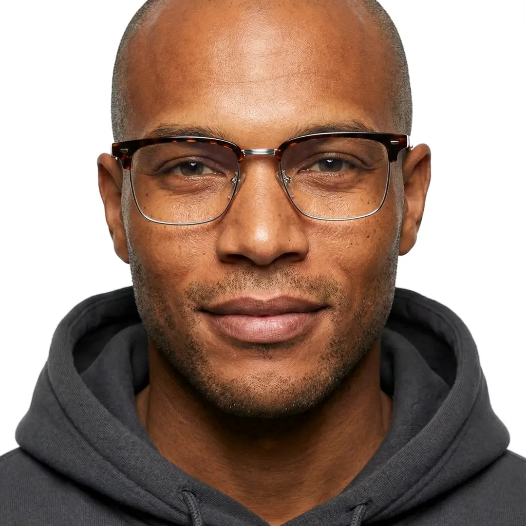 Front view of male wearing tortoise browline eyeglasses, soft smile, BX0402509