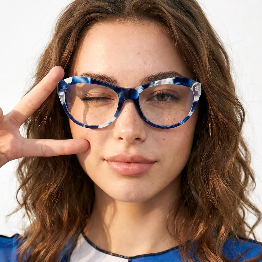 Front view of female wearing colorful blue cat eye eyeglasses, right hand peace sign, neutral expression, CA0032302