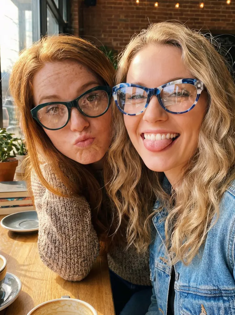 Two people models wearing geek chic blue and green cat eye acetate eyeglasses in a cafe with brick walls. SPU: CA0032302