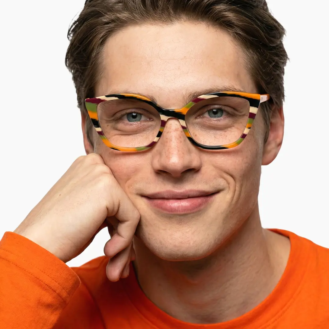 Front view of male wearing orange cat eye eyeglasses, hand near face, neutral expression, CA0102306