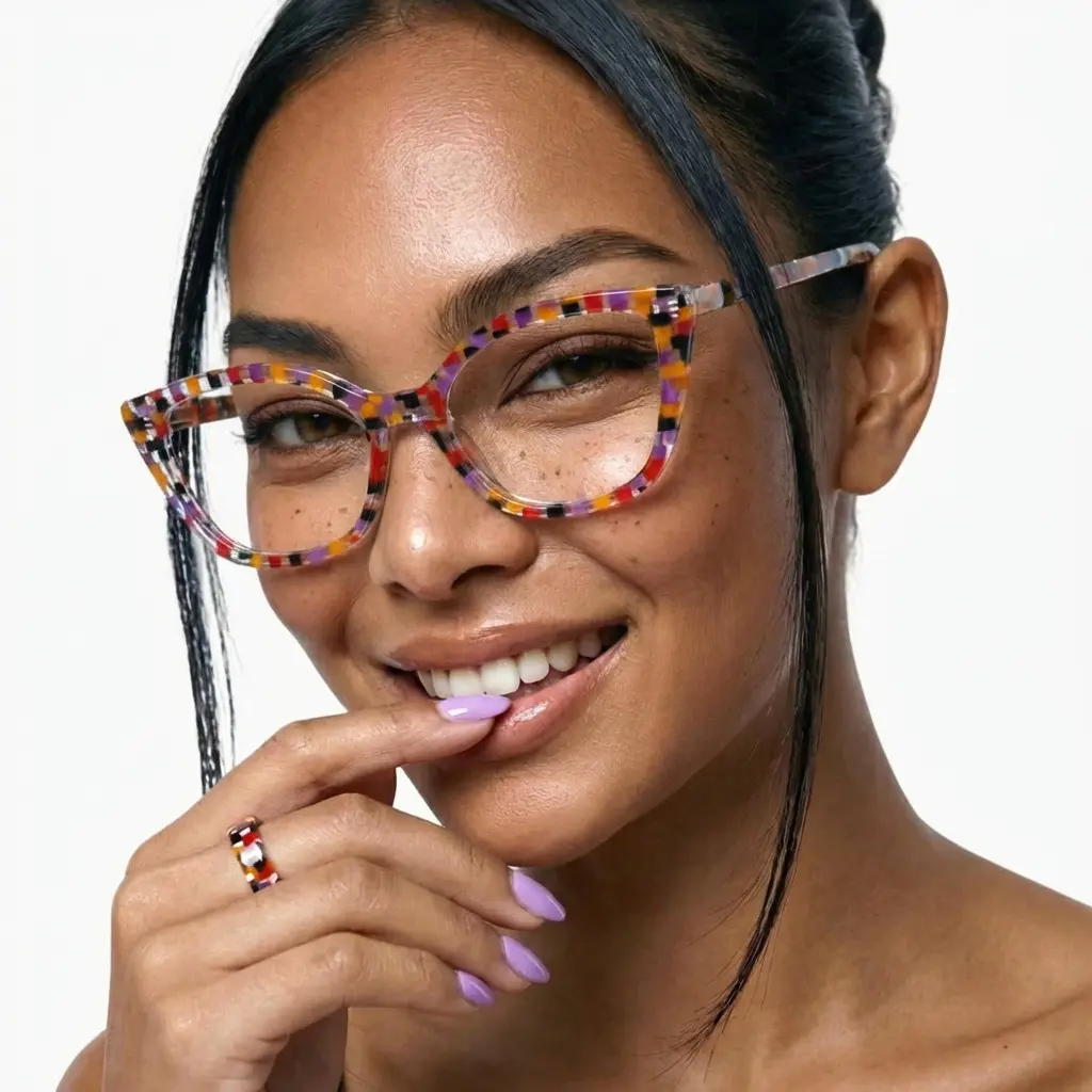 Close up of female wearing purple cat eye eyeglasses, resting chin on hand, wide smile, CA0102306