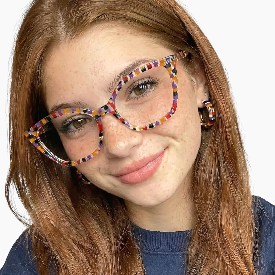 Profile view of female wearing purple cat eye eyeglasses, tilting head, natural smile, CA0102306