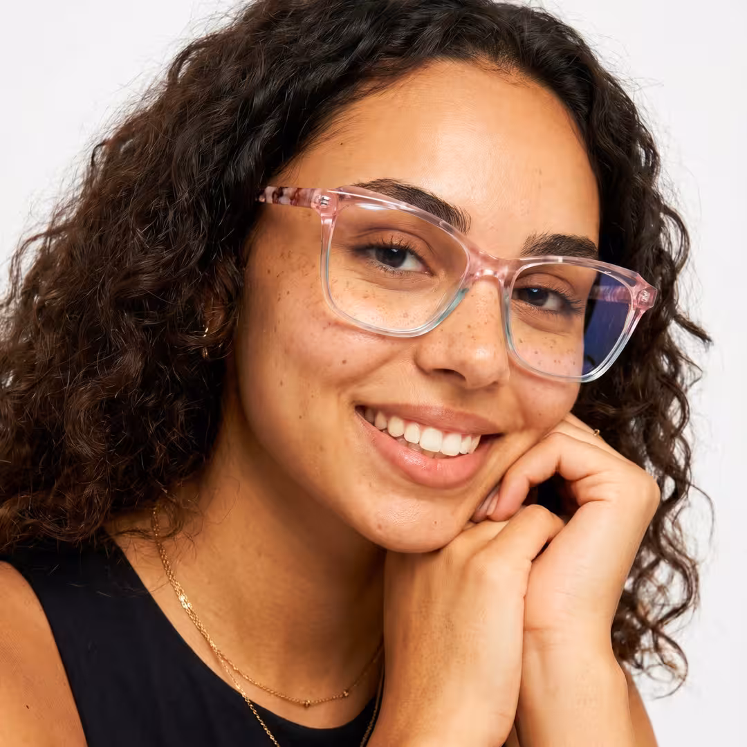 Female wearing colorful pink cat eye acetate eyeglasses, natural smile while hand near face. SPU: CA0332605