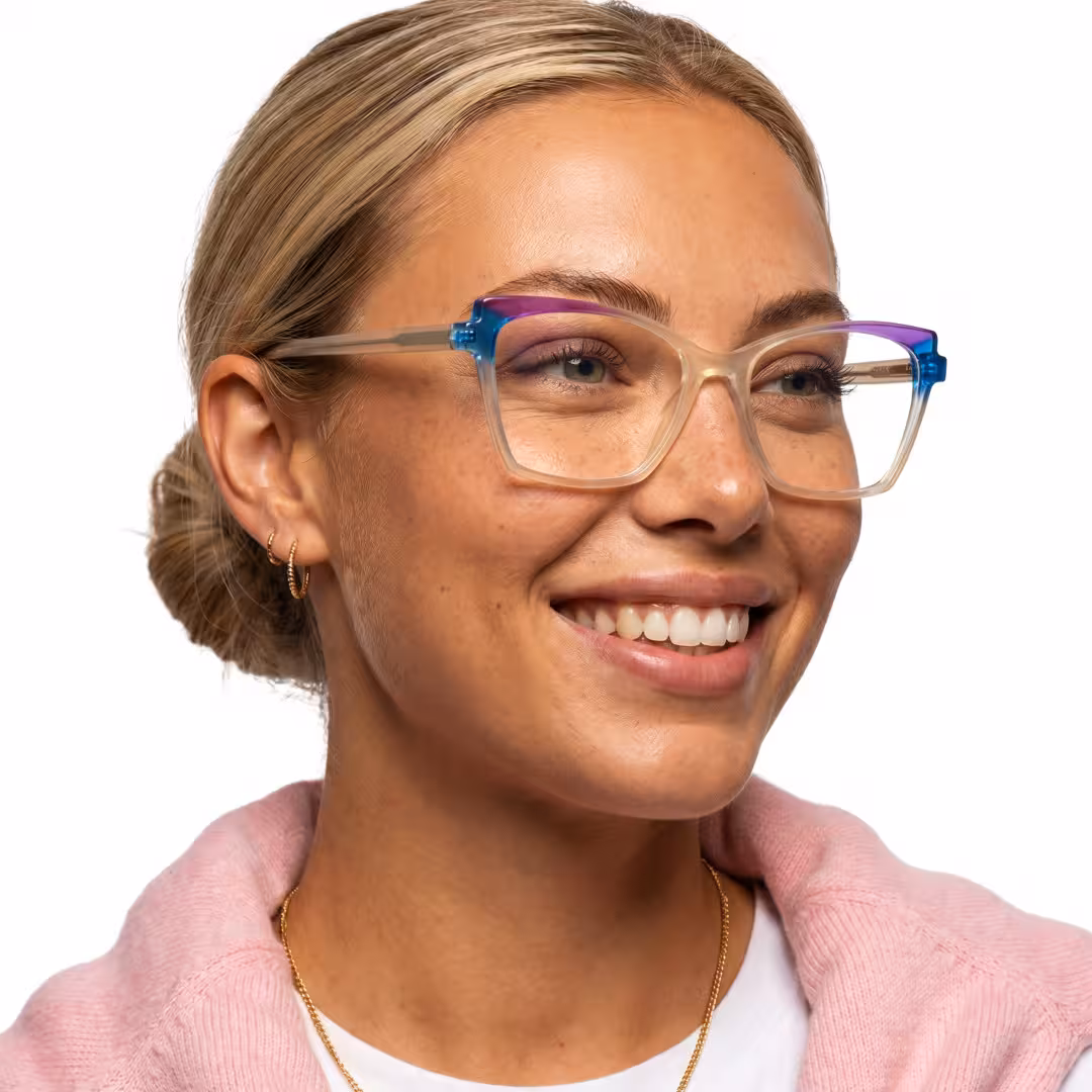 Female wearing colorful beige cat eye acetate eyeglasses, smiling while looking away. SPU: CA0352605