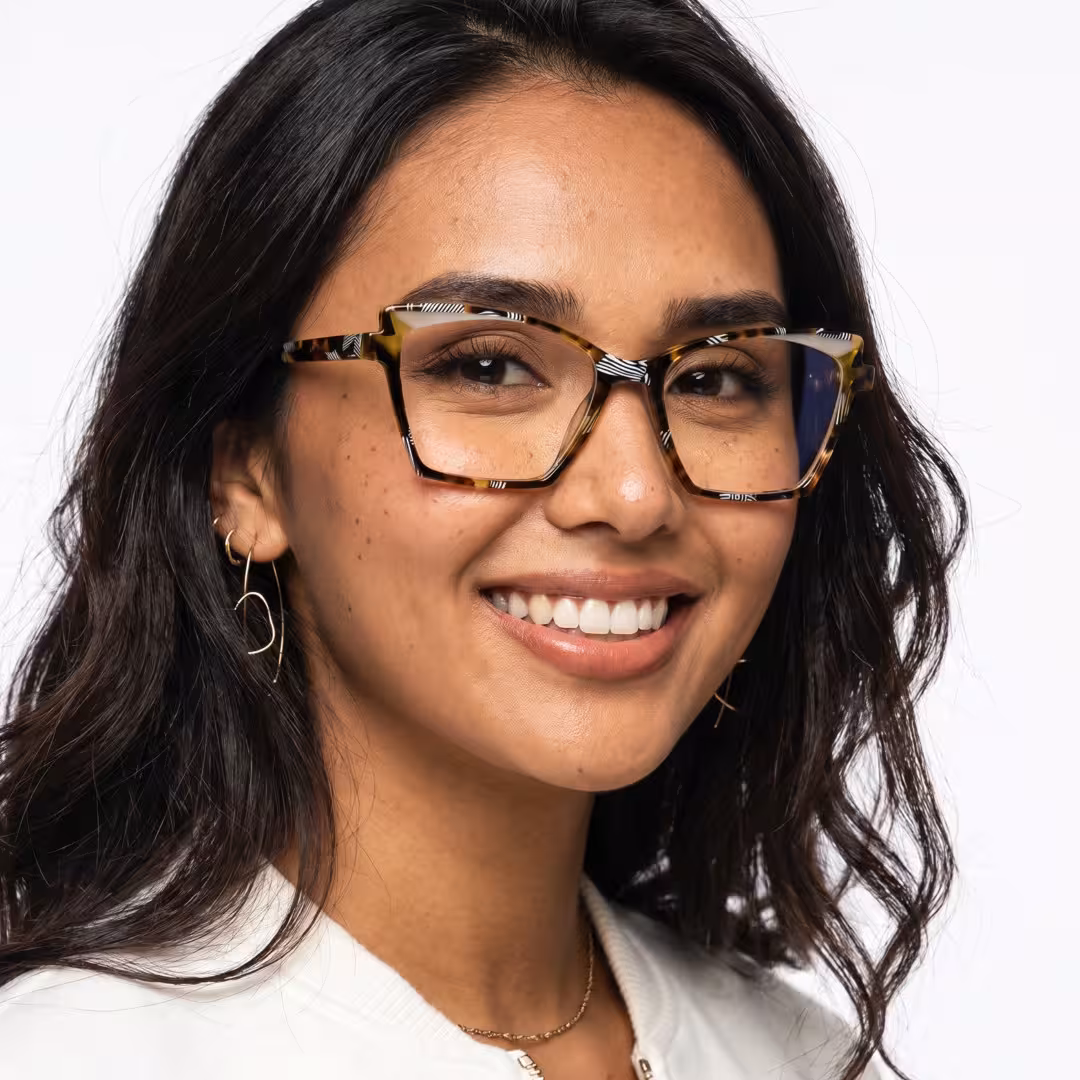 Female wearing colorful tortoise cat eye acetate eyeglasses, smiling while looking at camera. SPU: CA0352605