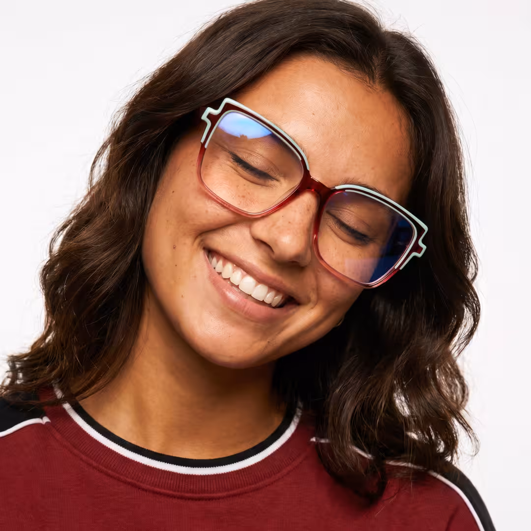 Female wearing colorful two tone cat eye acetate eyeglasses, eyes gently closed. SPU: CA0372605