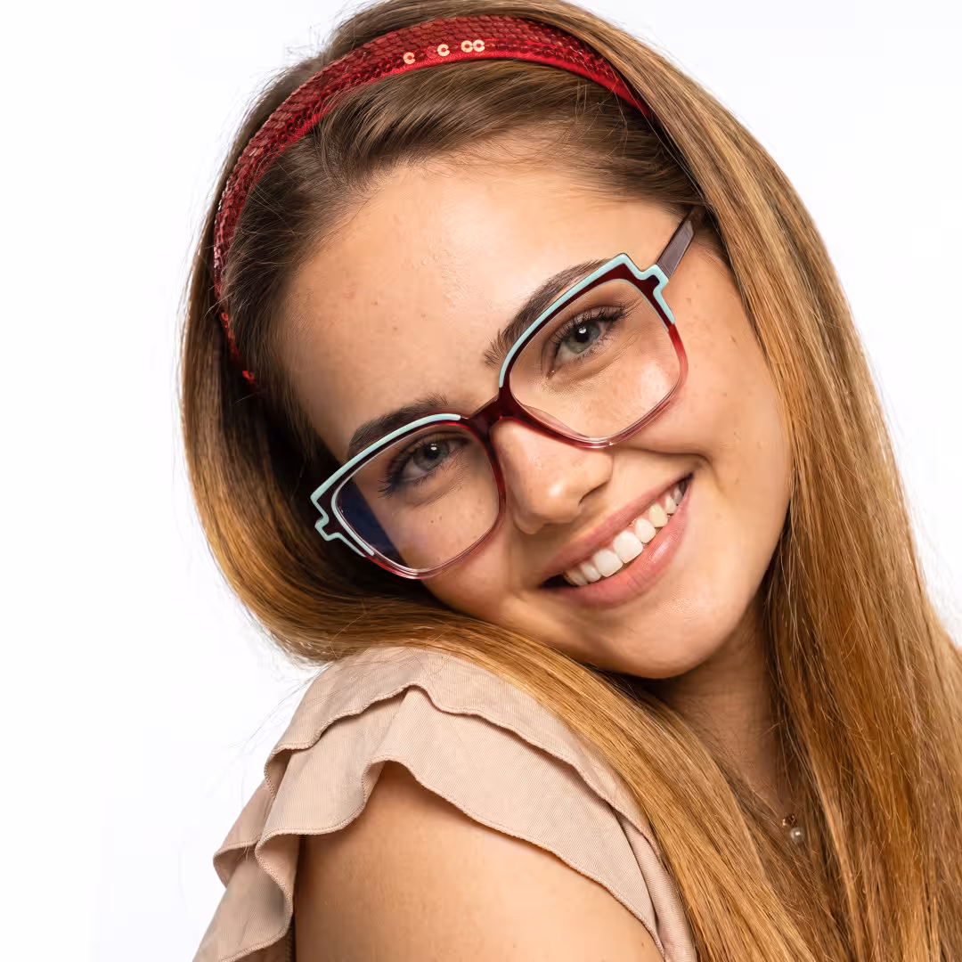 Female wearing colorful two tone cat eye acetate eyeglasses, smiling while looking at camera. SPU: CA0372605