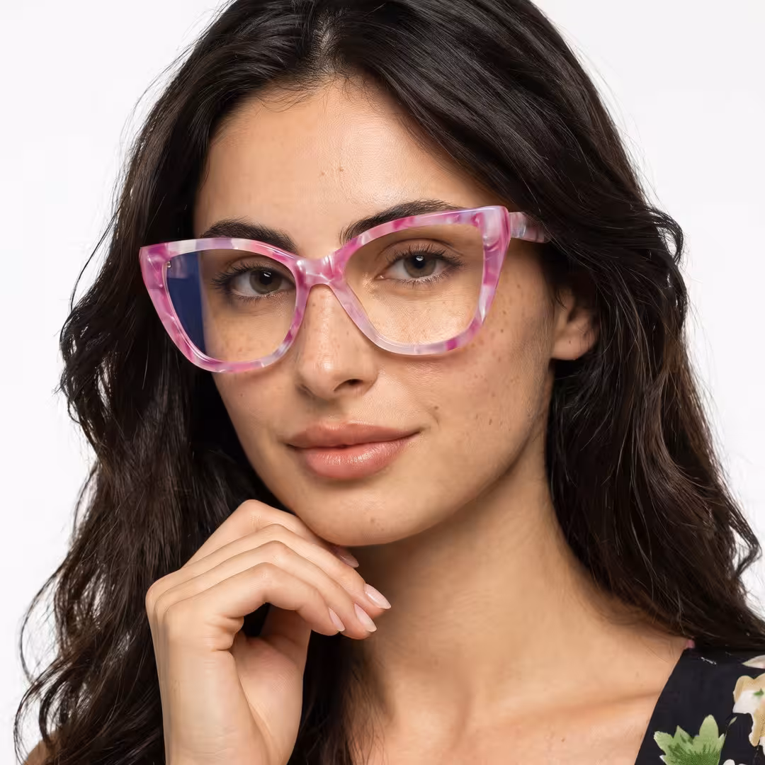 Female wearing colorful pink cat eye acetate eyeglasses, maintaining a neutral expression while moving hand near face. SPU: CA0432605