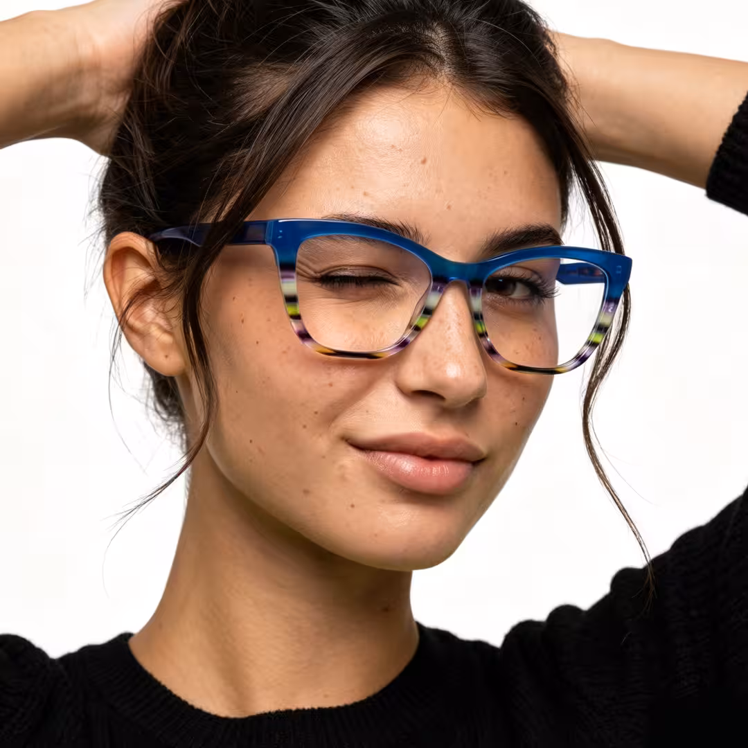 Female wearing colorful blue cat eye acetate eyeglasses, winking while placing hand on forehead. SPU: CA0452605